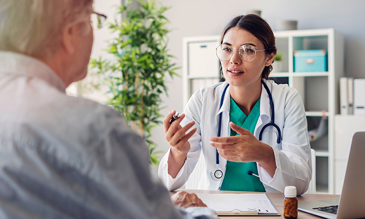 A doctor speaks to her patient