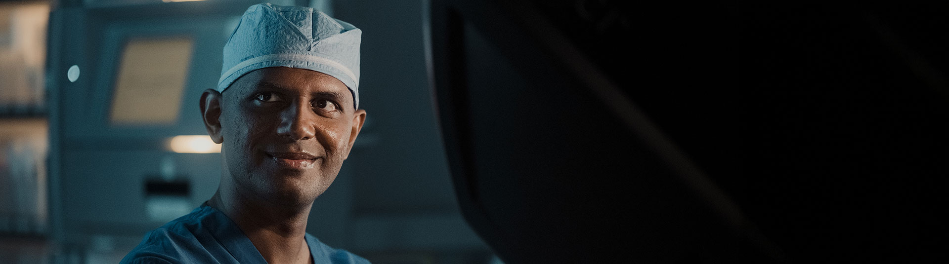 Surgeon smiling at the camera in an operation room