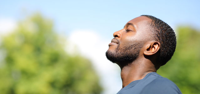 Man breathing clearly outdoors