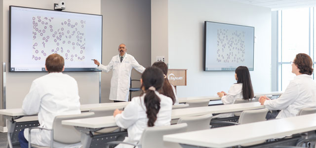 Hematology Oncology fellows listen to lecture from faculty member