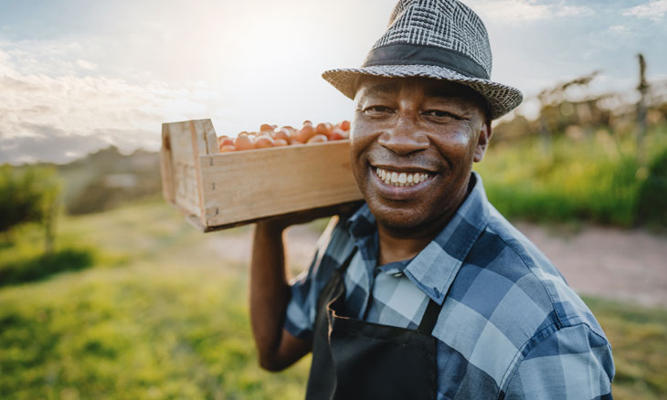 Man carrying a crate of strawberries